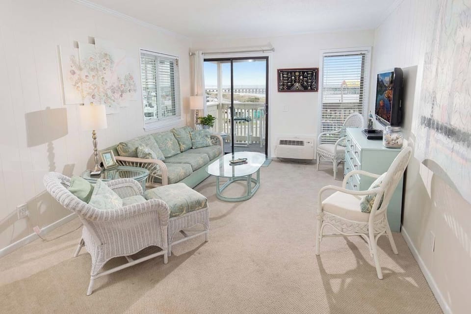 Living Room - Bright and comfortable living area with plenty of seating and ocean views, ideal for unwinding after a day at the beach.