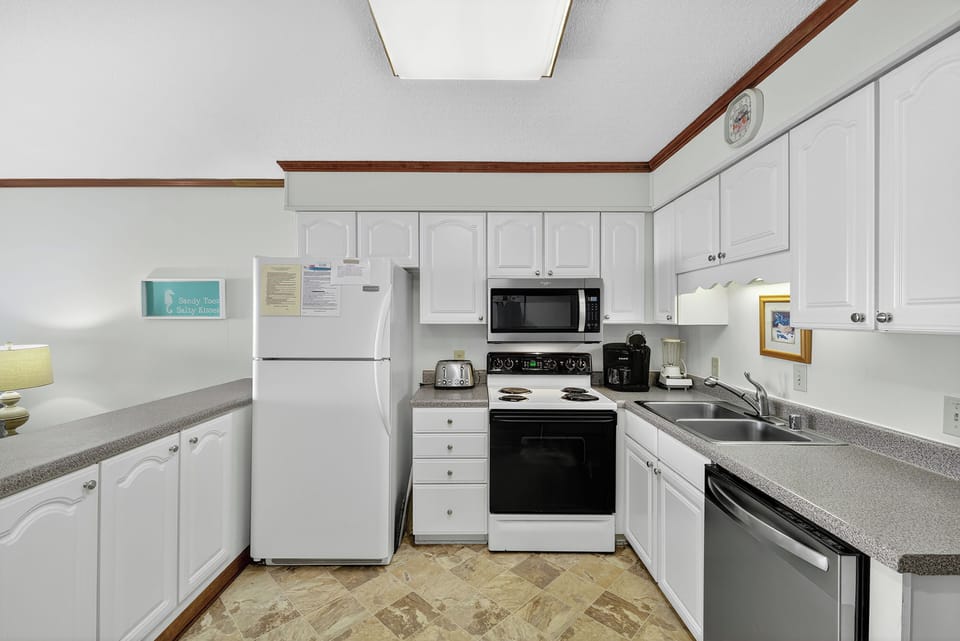 Kitchen - Full kitchen with modern appliances including stove, microwave, refrigerator, dishwasher, and all cookware you need for meal prep.