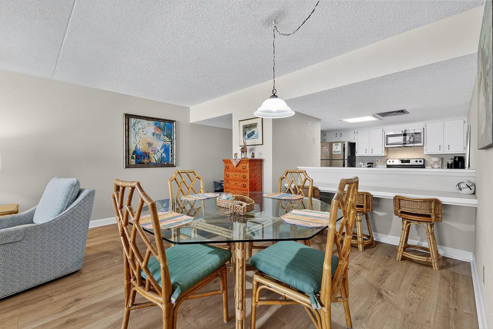Dining Area - Dining table located beside the living room and kitchen, providing space for meals or gathering together.