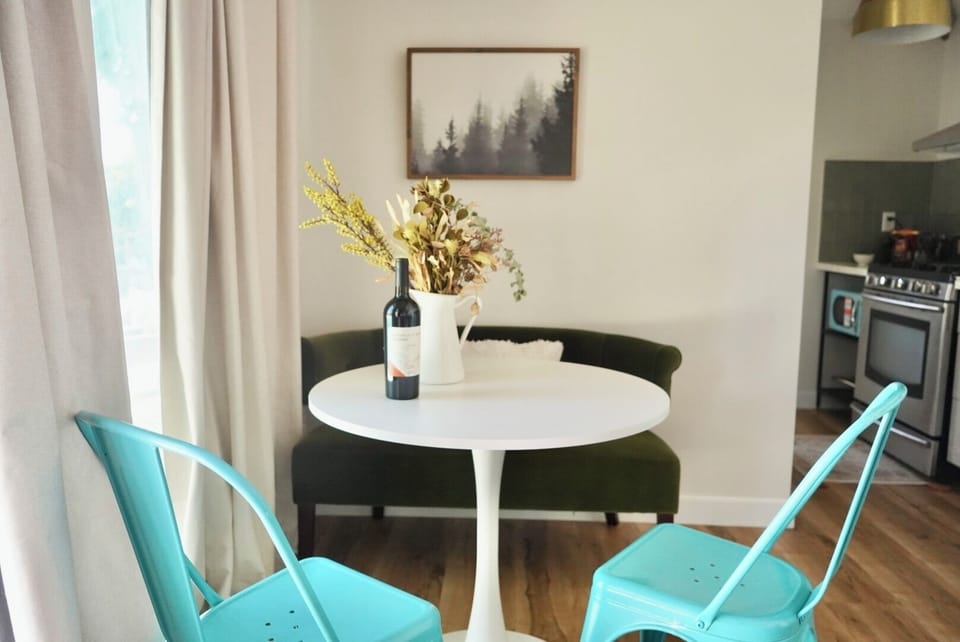 Round dining table with velvet 2 seater bench and bistro dining chairs