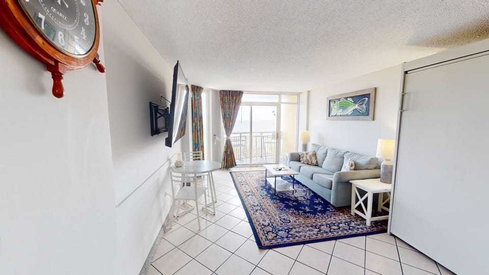 Living Room - Comfortable living space with flat‑screen TV — perfect for relaxing after a beach day.