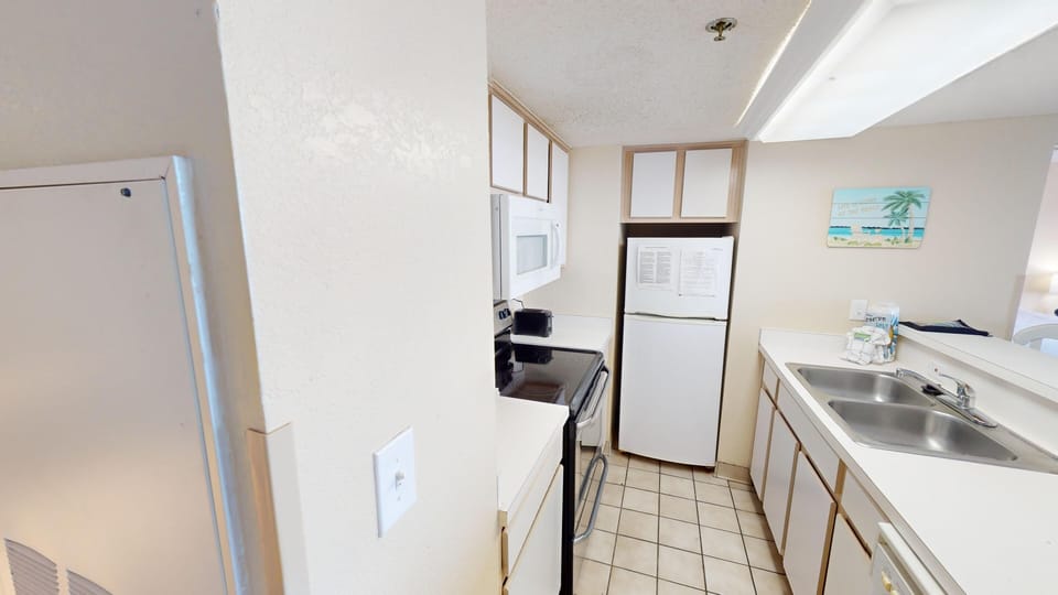 Kitchen - Prepare your favorite meals in the well-equipped kitchen with modern appliances and cookware.