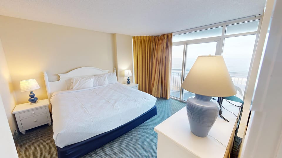 Bedroom One - Rest easy in the spacious master bedroom with cozy bedding and relaxation space.