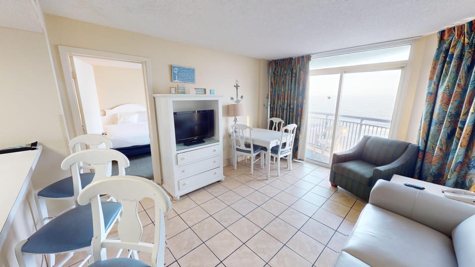 Living Room - Relax in the comfortable living space with three flat-screen TVs — perfect for movie nights with family or friends.