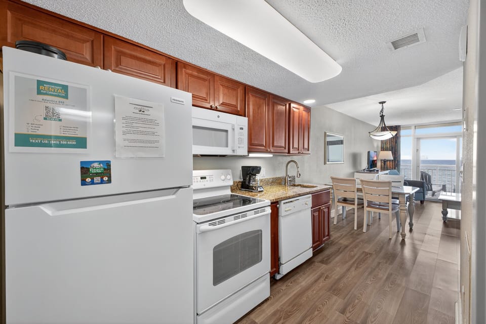 Kitchen - Prepare home-style meals with ease in the fully equipped kitchen with oven, stove, refrigerator, and cookware.