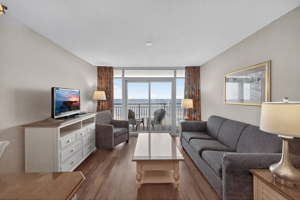 Living Room - Relax with family or friends in this comfortable living area featuring plenty of seating and flat-screen TVs.
