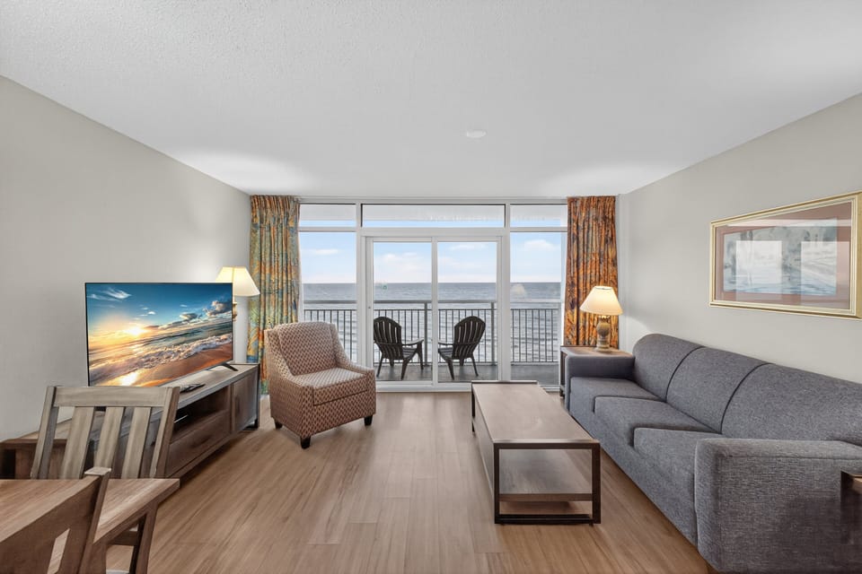 Living room - Relax after a day at the beach in the comfortable living space with two flat-screen TVs — perfect for movie nights.