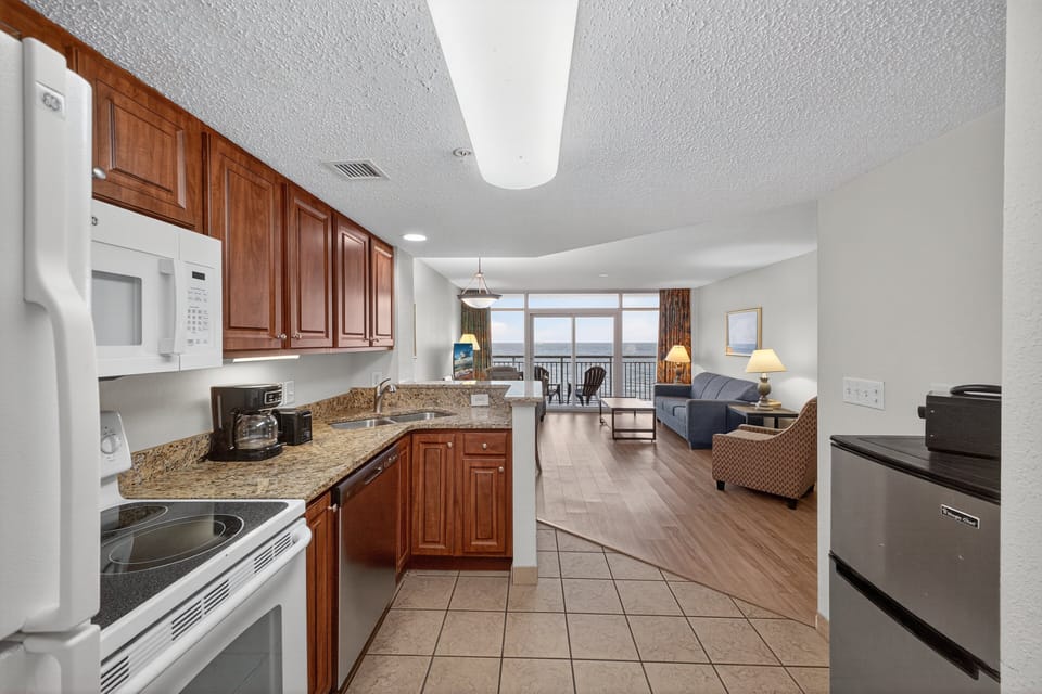 Kitchen - Prepare family meals in the fully equipped kitchen with stove, oven, refrigerator, dishwasher, and essential cookware.