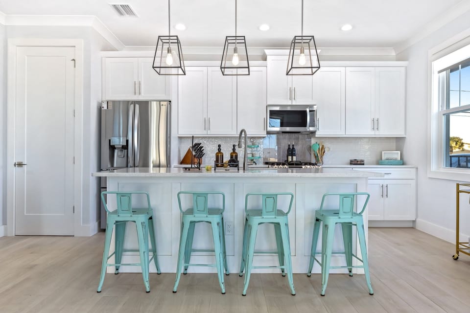 Fully equipped kitchen with bar seating and bar cart. This space is perfect for entertaining guests during the day.