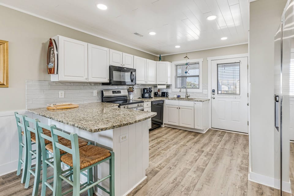 Kitchen area with a breakfast bar that seats four.