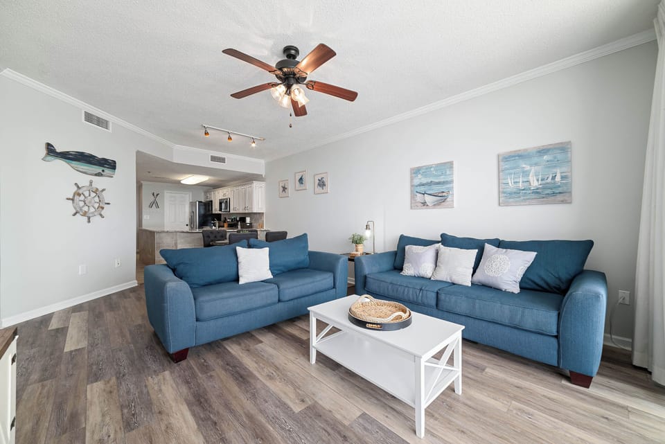 Enjoy the beach vibes in this beautifully decorated living room with comfortable sofas and a relaxing atmosphere. Your perfect vacation getaway starts here.