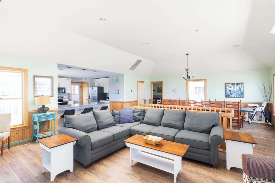 Top Level Living Area with comfortable seating, large window and easy access to the deck, with natural light.