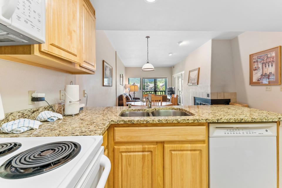 Your fully equipped kitchen features granite countertops and modern appliances, perfect for preparing meals while enjoying the open layout.