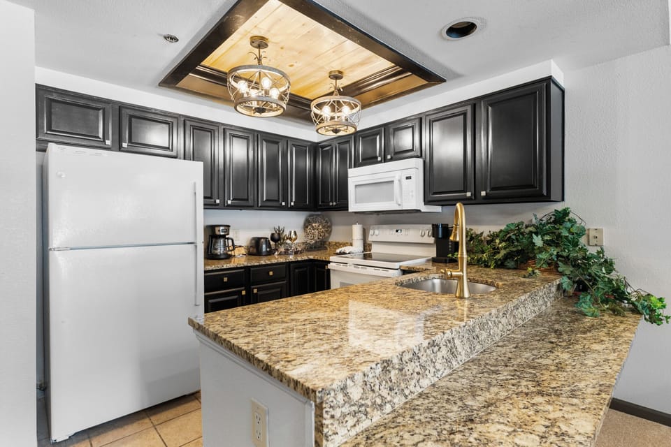 Your fully equipped kitchen features granite countertops and elegant pendant lighting for memorable meal prep.