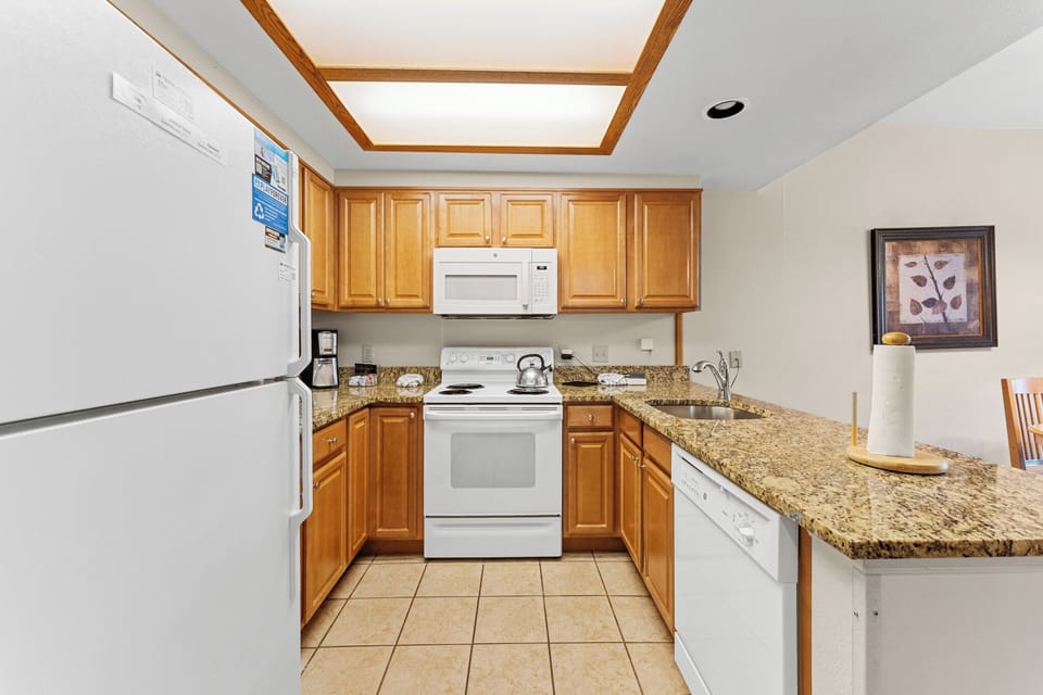 Your fully equipped kitchen features granite countertops, warm wood cabinets, and everything needed for home-cooked meals during your stay.