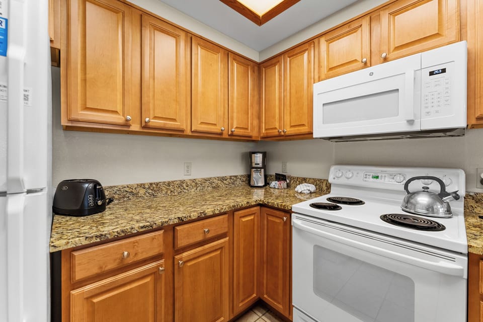 Your fully equipped kitchen features warm wood cabinets, granite countertops, and all appliances needed to prepare memorable meals during your stay.