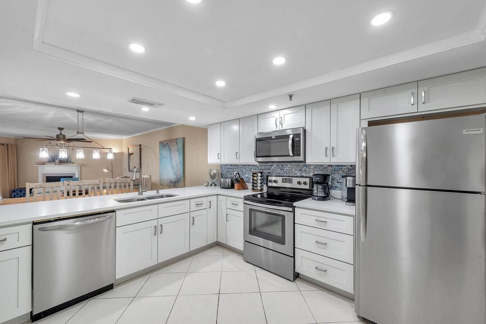 Fully equipped kitchen w/ stainless appliances, generous counters, and plenty of storage.
