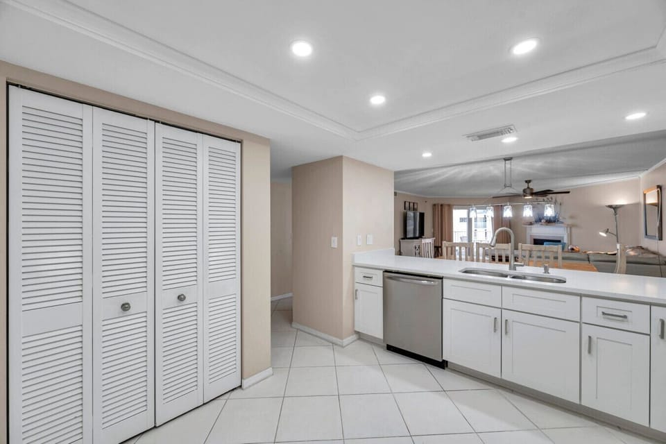 Stylish kitchen w/ patterned backsplash, modern lighting, and a fresh coastal vibe.