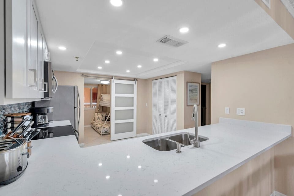 Large kitchen island w/ seating, perfect for casual meals or gathering after a beach day.