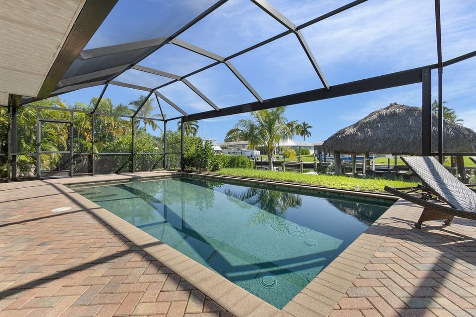 heataed pool with views of tiki hut and canal