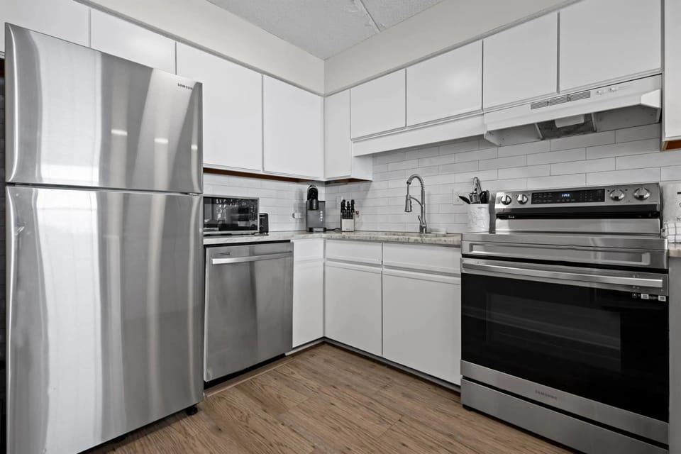 Updated kitchen with sleek stainless steel appliances, combining modern style with functionality for a perfect cooking experience.