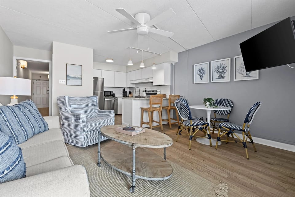 Cozy living room featuring a smart TV, updated décor, and a comfortable atmosphere perfect for relaxation and entertainment.