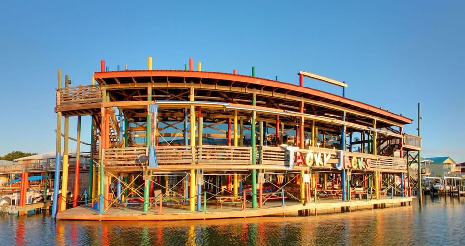 Tacky Jacks is a fun waterfront restaurant offering a casual vibe, fresh seafood, hearty breakfasts, and their famous "Mexican Garbage" nachos. With live music, stunning views of Cotton Bayou, and both indoor and outdoor seating, it’s a favorite spot!