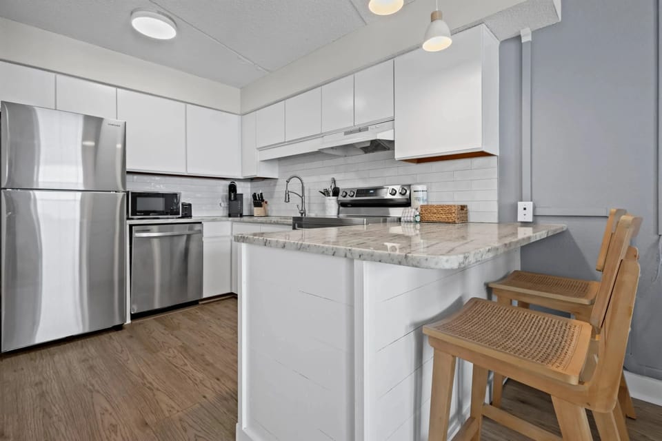 Modern updated kitchen featuring sleek appliances, stylish countertops, and all the essentials for cooking and dining.