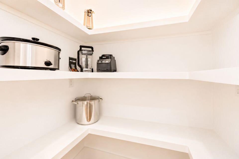 Functional interior storage and utility nook with open shelving, countertop space and small appliances, providing extra organization for an extended beach stay.