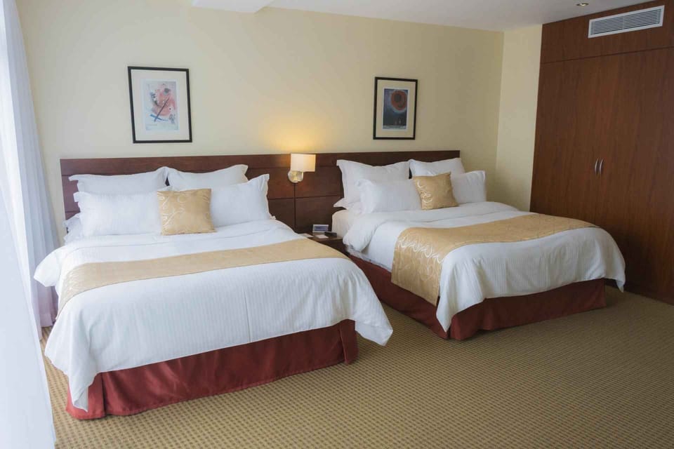Deluxe Quadruple Room, Balcony, City View | Minibar, in-room safe, desk, laptop workspace