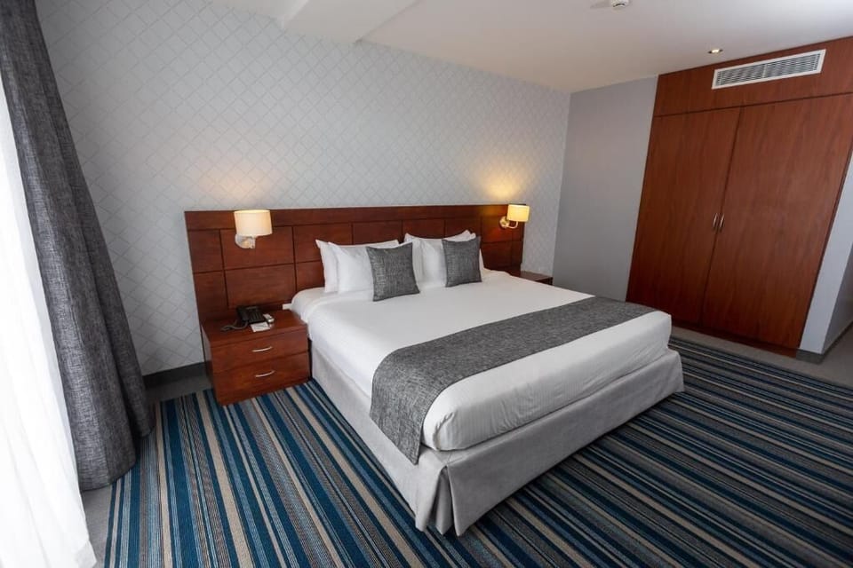 Deluxe Double Room, Balcony, City View | Minibar, in-room safe, desk, laptop workspace