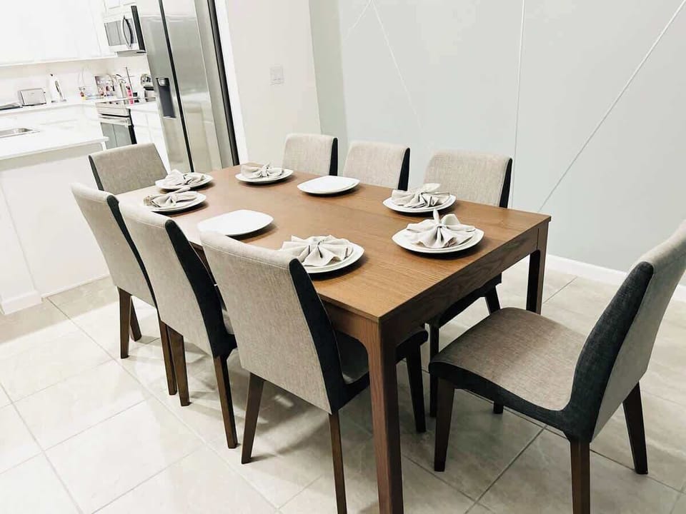 Elegant dining area seats 8 wood table Kissimmee retreat