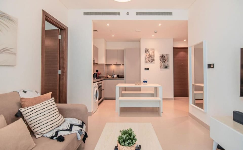 This stylish open-plan living space is perfect for relaxation, with its cozy seating, sleek furniture, and easy access to the kitchen and dining area.