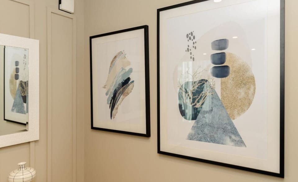 Modern artwork adds a touch of sophistication to the living space, creating a chic and relaxing ambiance.