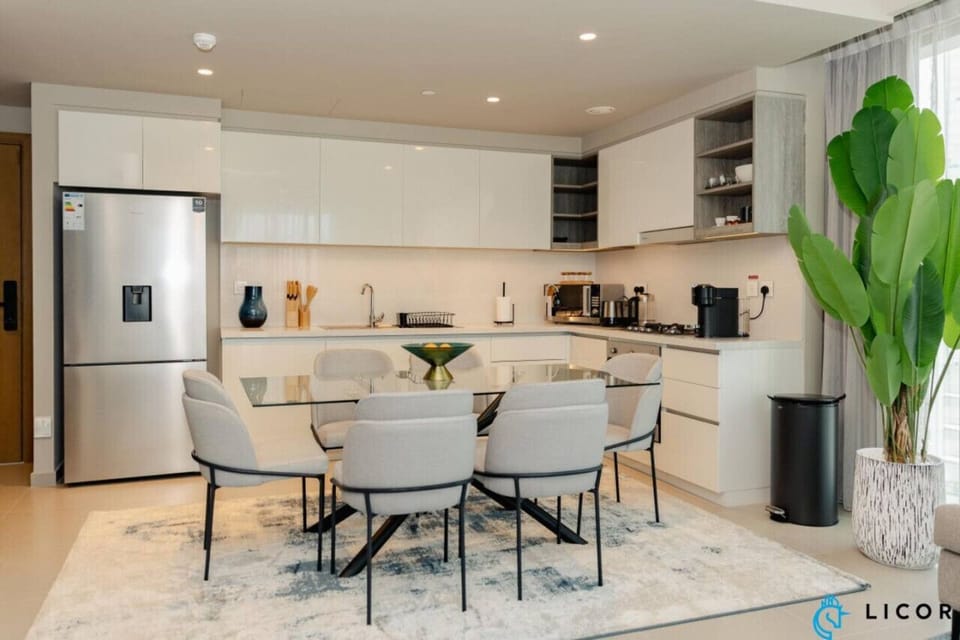 Modern kitchen with sleek appliances, adjacent to a chic dining space, perfect for entertaining