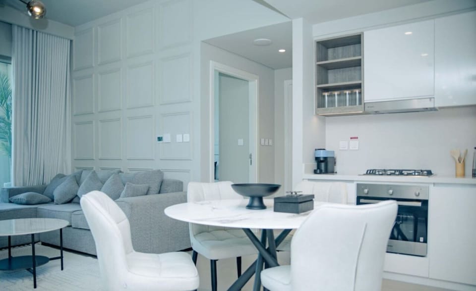 Bright and open living and dining area with comfortable seating and elegant decor, perfect for unwinding.
