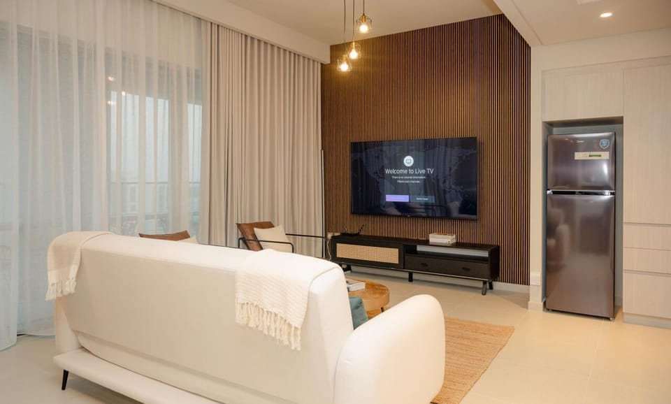Relax in this stylish living room with a sleek flat-screen TV, modern furniture, and a cozy atmosphere that invites you to unwind.