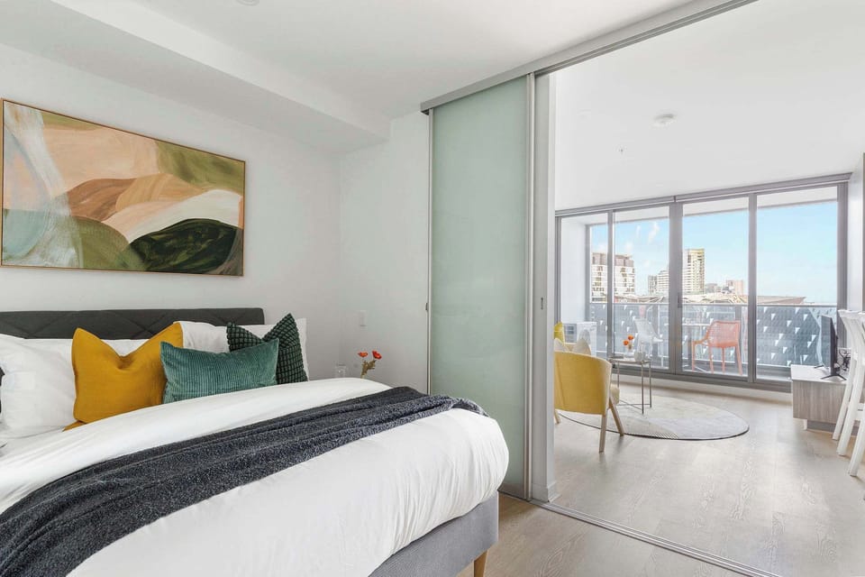 A second bedroom with a queen sized bed & plush pillows.