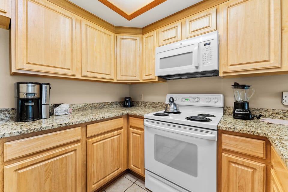 Your fully equipped kitchen features granite counters and modern appliances for preparing home-cooked meals during your stay.