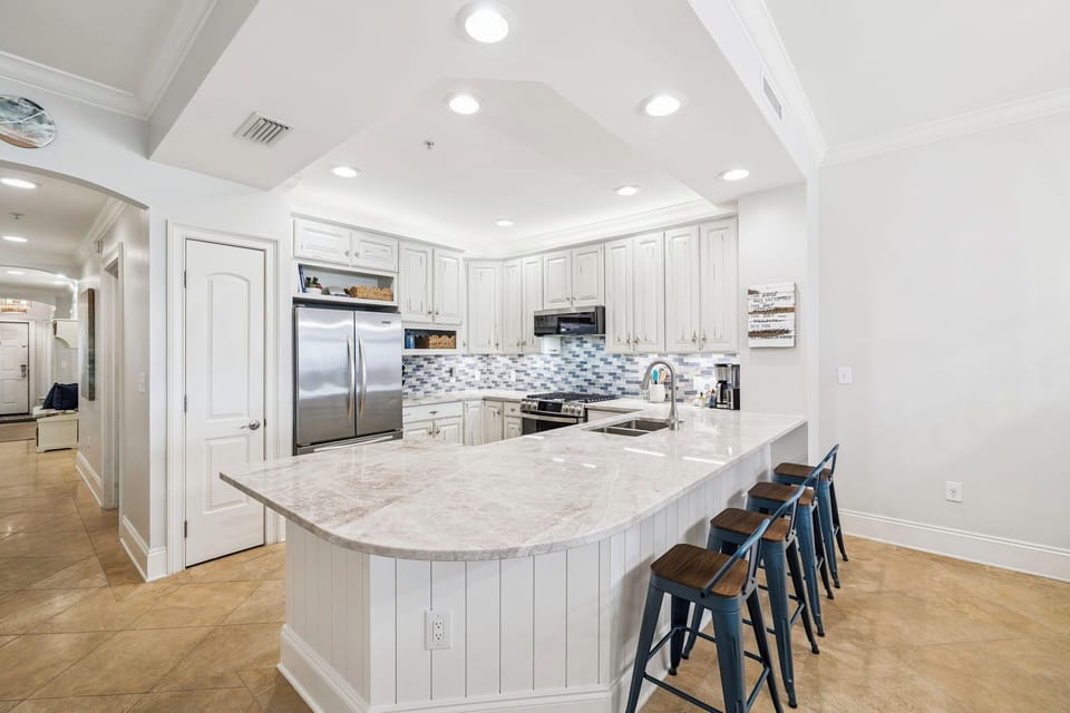 Cook memorable meals in your spacious gourmet kitchen featuring pristine white cabinetry, granite countertops, and modern stainless appliances—perfect for gathering with loved ones.