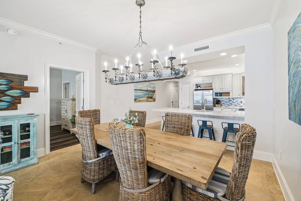 Your open dining space flows into a gourmet kitchen, where coastal charm meets modern convenience for memorable meals together.