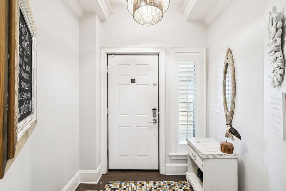 Step into your welcoming entryway with coastal charm—white shutters, nautical touches, and thoughtful details create the perfect arrival experience.