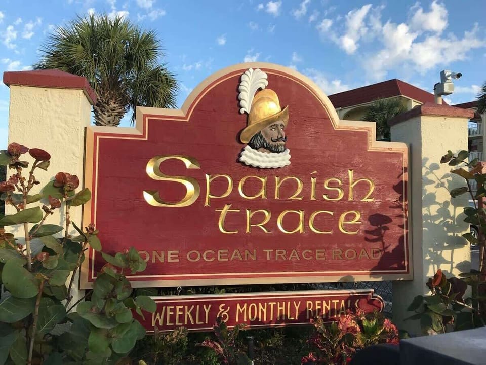 - Spanish Trace resort entrance sign welcomes weekly and monthly vacationers  
- Beachfront location makes this property highly desirable for guest stays  
- A trusted community offering comfort convenience and coastal charm