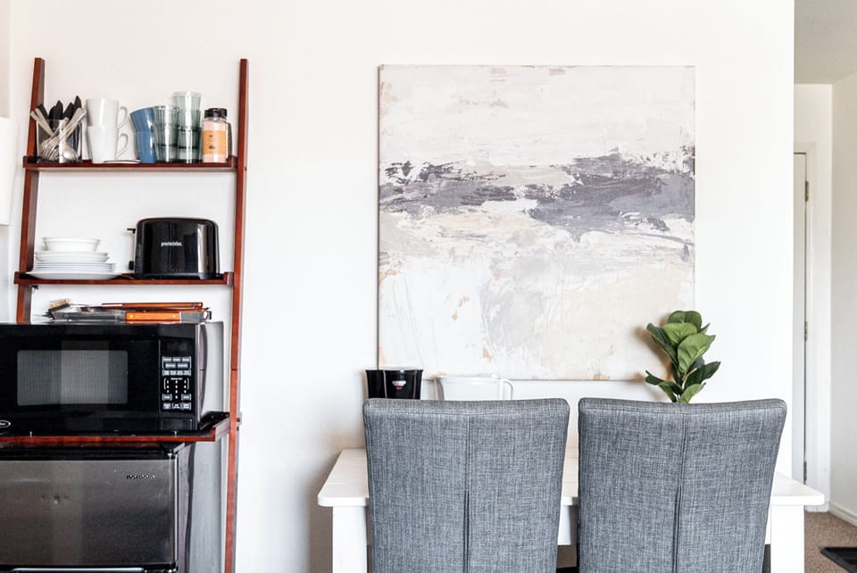 Workspace meets kitchenette. Desk area for all of our remote workers, and a basic kitchenette and coffee station to get you through the day, until you can venture outside!