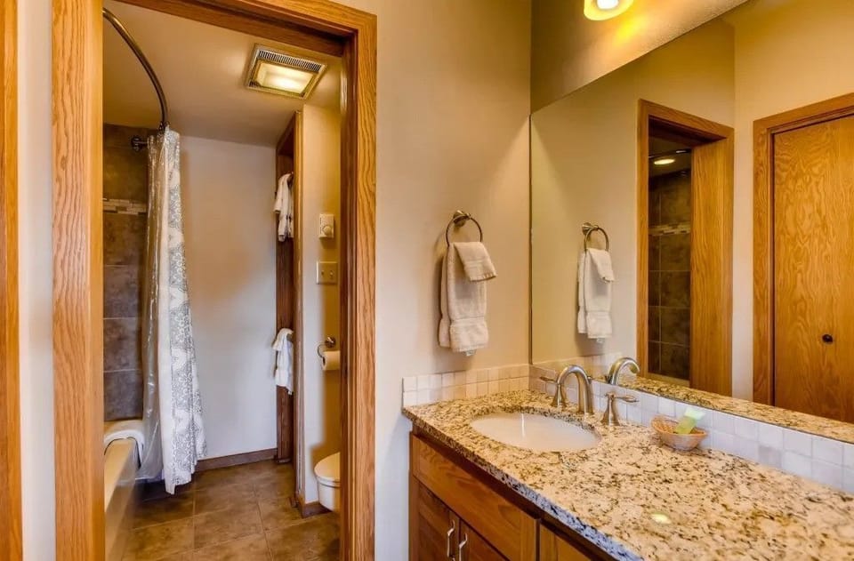 Complete with contemporary amenities, the second bathroom is a stylish sanctuary, featuring a walk-in shower and warm tones that enhance the overall tranquility of the condo.