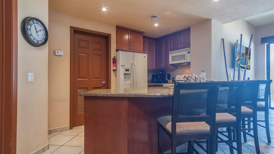 The kitchen is bordered by a large counter with seating for casual get togethers.