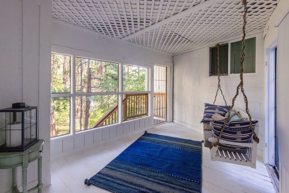 Cozy enclosed porch with a relaxing swing seat.