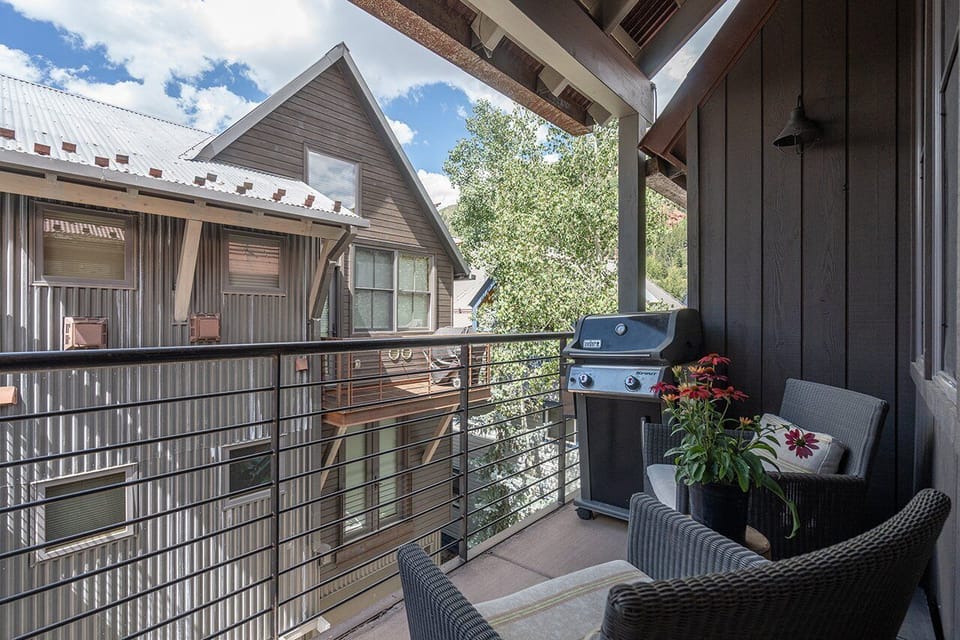 This private deck, located just off the living area, is perfect for soaking in the views or grilling up some delicious food in a relaxed outdoor setting.