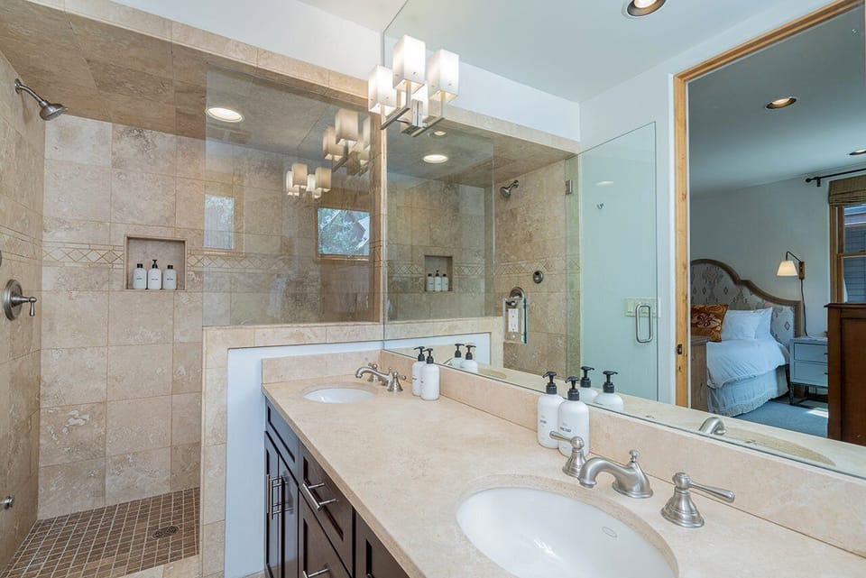 The large, spacious ensuite bathroom features a generous step-in tiled shower and a double vanity, creating a luxurious and functional space.