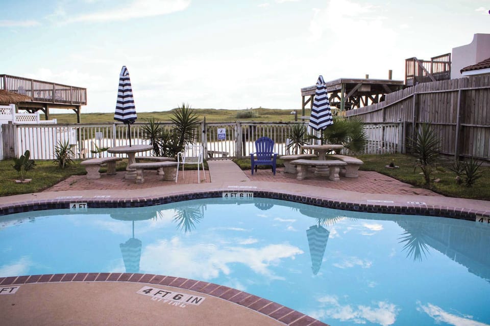 Relax by the pool and soak in serene canal views